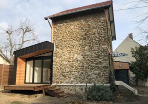 Le pignon existant et l'extension qui entoure la maison